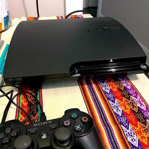 PlayStation PS3 console with cords and one controller, tested